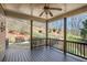 Covered porch with wooden railing and flooring overlooking a private backyard with mature trees at 4710 Mcintosh Dr, Cumming, GA 30040