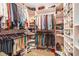 Well-organized walk-in closet with ample shelving and hanging space for clothes and shoes at 4710 Mcintosh Dr, Cumming, GA 30040