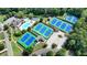 Community amenities featuring tennis courts and swimming pool amidst lush green landscaping at 2510 Bent Creek Way, Cumming, GA 30041