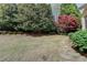 Large grassy backyard with mature trees and a stone path at 2510 Bent Creek Way, Cumming, GA 30041