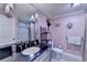 Elegant bathroom featuring a black countertop, modern fixtures, and a tiled shower at 2510 Bent Creek Way, Cumming, GA 30041