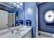 Stylish blue bathroom featuring a marble shower, updated vanity, and modern fixtures at 2510 Bent Creek Way, Cumming, GA 30041