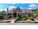 A beautiful brick and stone clubhouse welcomes visitors with landscaping, a stone walkway, and nice details at 2510 Bent Creek Way, Cumming, GA 30041