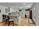 Open kitchen featuring white cabinets, granite countertops, and a large island with bar seating at 2510 Bent Creek Way, Cumming, GA 30041