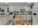 Well-lit kitchen with white cabinetry, stainless steel appliances, and a center island for food preparation at 2510 Bent Creek Way, Cumming, GA 30041