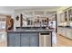 Modern kitchen island featuring a granite countertop, stainless steel dishwasher, and custom-painted cabinetry at 2510 Bent Creek Way, Cumming, GA 30041