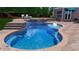 A beautiful custom pool with a waterfall feature and stone patio is ready for Summer at 2510 Bent Creek Way, Cumming, GA 30041