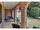 Inviting brick porch features a swing and comfortable seating area at 2510 Bent Creek Way, Cumming, GA 30041