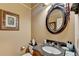 Well appointed powder room with decorative mirrors, granite countertop, and traditional fixtures at 2510 Bent Creek Way, Cumming, GA 30041