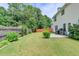 A level, green lawn, patio, wooden fence, and shrubbery define this backyard at 3285 Watson Gate Rd, Loganville, GA 30052