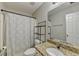 Bright bathroom with granite counters and a white shower curtain at 3285 Watson Gate Rd, Loganville, GA 30052