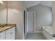 Bright bathroom with granite countertops, a white cabinet, and a large soaking tub at 3285 Watson Gate Rd, Loganville, GA 30052