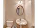 Powder room with a pedestal sink and a decorative mirror at 3285 Watson Gate Rd, Loganville, GA 30052