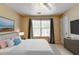 Comfortable bedroom features a ceiling fan, carpet flooring, and a large window at 3285 Watson Gate Rd, Loganville, GA 30052