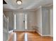 Bright foyer features wood floors, a white front door with side lights and trim, and a coat closet at 3285 Watson Gate Rd, Loganville, GA 30052