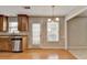 Open-concept kitchen with stainless steel dishwasher, wood cabinets, and eat-in breakfast area at 3285 Watson Gate Rd, Loganville, GA 30052