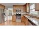 Kitchen boasts stainless steel appliances, stone countertops, wood cabinets, and hardwood floors at 3285 Watson Gate Rd, Loganville, GA 30052