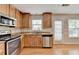 Cozy kitchen featuring stainless steel appliances, wood cabinets, and light stone countertops at 3285 Watson Gate Rd, Loganville, GA 30052