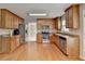 Spacious kitchen with stainless steel appliances, stone countertops, wood cabinets, and hardwood floors at 3285 Watson Gate Rd, Loganville, GA 30052