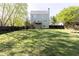 Rear view of the home showing the yard and patio area with wooden stairs at 55 Maple Leaf Ct, Dallas, GA 30157