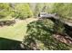 Spacious, grassy backyard with a wooden fence and mature trees, offering a private outdoor space at 55 Maple Leaf Ct, Dallas, GA 30157