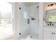Bathroom shower with frameless glass and white tile surround, complemented by black fixtures at 55 Maple Leaf Ct, Dallas, GA 30157