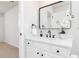 Bathroom featuring white vanity with quartz countertop, black hardware, and modern mirror at 55 Maple Leaf Ct, Dallas, GA 30157