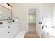 Bathroom features a soaking tub, vanity with quartz counters, and access to primary bedroom at 55 Maple Leaf Ct, Dallas, GA 30157
