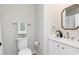 Bathroom features updated vanity, decorative mirror, and modern toilet at 55 Maple Leaf Ct, Dallas, GA 30157