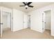 A cozy bedroom with neutral walls, carpet, a ceiling fan, and access to a bathroom and closet at 55 Maple Leaf Ct, Dallas, GA 30157