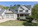 Charming two-story home with a manicured front lawn and a three car garage at 55 Maple Leaf Ct, Dallas, GA 30157