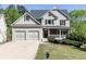 Charming home featuring manicured lawn, two-car garage, and inviting front porch at 55 Maple Leaf Ct, Dallas, GA 30157