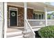 Inviting front porch featuring stone accents, white railing, and a decorative wreath at 55 Maple Leaf Ct, Dallas, GA 30157
