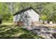 View of the exterior of the detached garage showing the stone accents and the surrounding yard at 55 Maple Leaf Ct, Dallas, GA 30157