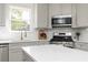 Bright eat-in kitchen offers stainless steel appliances, gray cabinets, and white countertops at 55 Maple Leaf Ct, Dallas, GA 30157