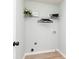 Compact laundry room featuring wire shelving, utility hookups, and minimalist design at 55 Maple Leaf Ct, Dallas, GA 30157