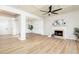 Open-concept living room with a fireplace, coffered ceiling, and hardwood floors at 55 Maple Leaf Ct, Dallas, GA 30157