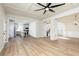 Open-concept living space with a fireplace, hardwood floors, and kitchen access at 55 Maple Leaf Ct, Dallas, GA 30157
