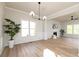 Spacious living room with a fireplace, natural light, and decorative wainscoting at 55 Maple Leaf Ct, Dallas, GA 30157