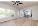 Open-concept living room with hardwood floors, a kitchen, and a backyard view at 55 Maple Leaf Ct, Dallas, GA 30157