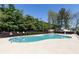 Community pool featuring a diving board and mature trees at 55 Maple Leaf Ct, Dallas, GA 30157