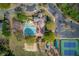 Aerial view of community pool, playground, tennis courts, and clubhouse with ample parking at 5808 Deer Crossing Dr, Sugar Hill, GA 30518