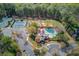 Aerial view of community amenities including tennis courts and a pool at 5808 Deer Crossing Dr, Sugar Hill, GA 30518