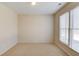 Clean and simple bedroom with neutral carpet features blinds and natural light, with fresh, neutral paint at 5808 Deer Crossing Dr, Sugar Hill, GA 30518