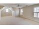 Spacious bedroom features plush carpeting, neutral walls, and natural light from three windows at 5808 Deer Crossing Dr, Sugar Hill, GA 30518
