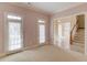 Bright bonus room featuring neutral walls, carpet, and doors leading to the outside at 5808 Deer Crossing Dr, Sugar Hill, GA 30518