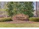 Stone community sign for Wild Timber, surrounded by manicured landscaping at 5808 Deer Crossing Dr, Sugar Hill, GA 30518