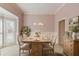 Elegant dining room boasts natural light, a rustic table, and decorative accents at 5808 Deer Crossing Dr, Sugar Hill, GA 30518