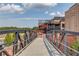 Exterior view of mixed use space with dining and lake views in a brick building at 5808 Deer Crossing Dr, Sugar Hill, GA 30518