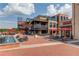 Exterior view of mixed use space with dining and retail including Scoops ice cream shop at 5808 Deer Crossing Dr, Sugar Hill, GA 30518